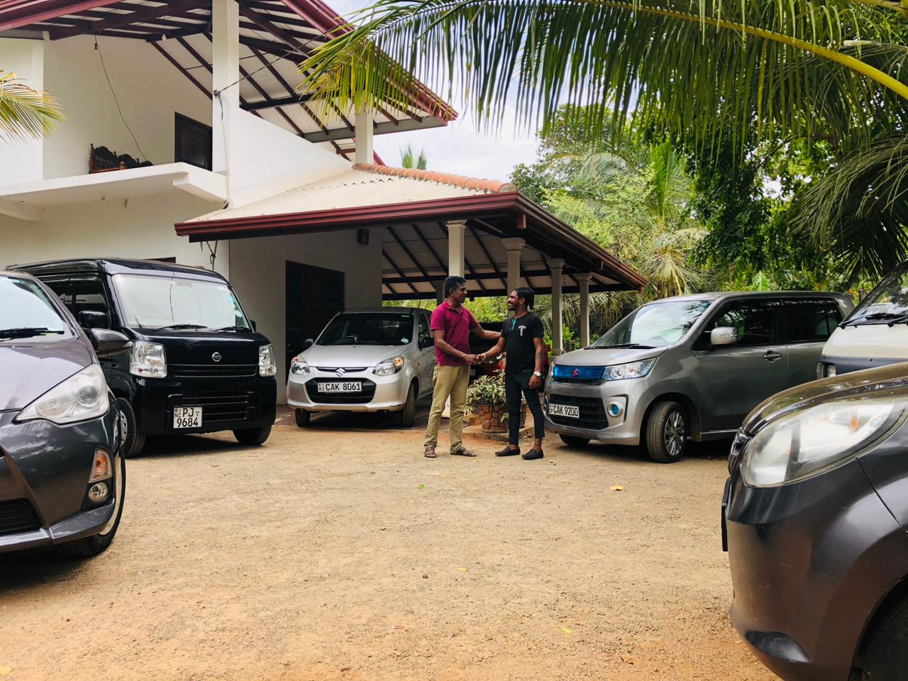 Anuradhapura wagoncab car rental service owner and a customer doing business in the business location.